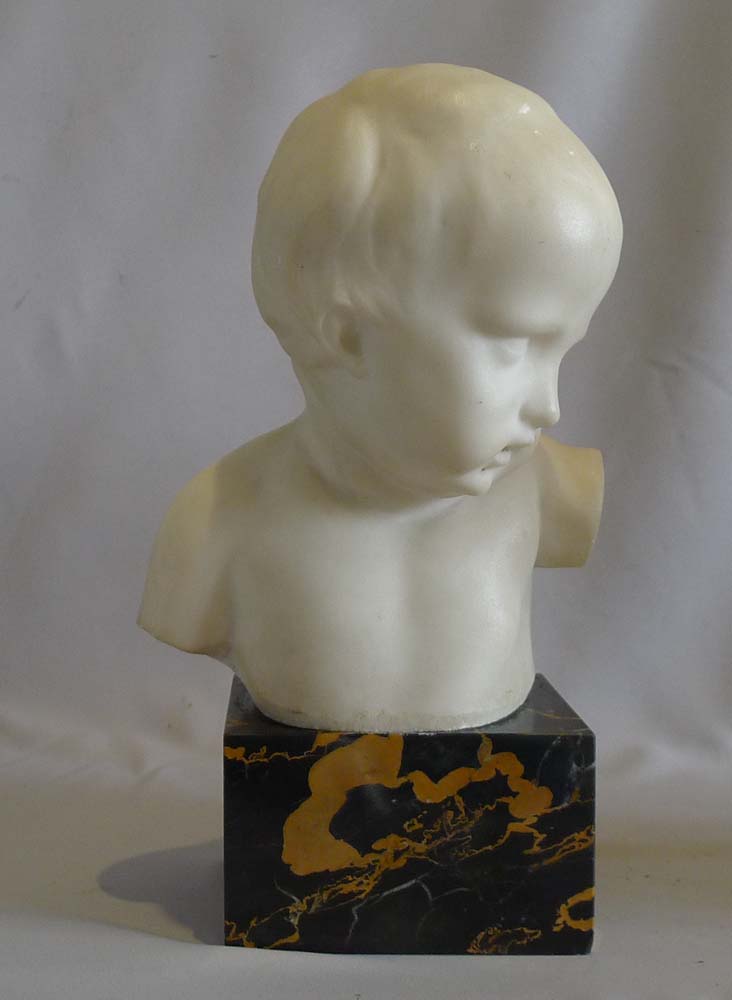 Antique pair of white marble busts of children on variegated marble bases.