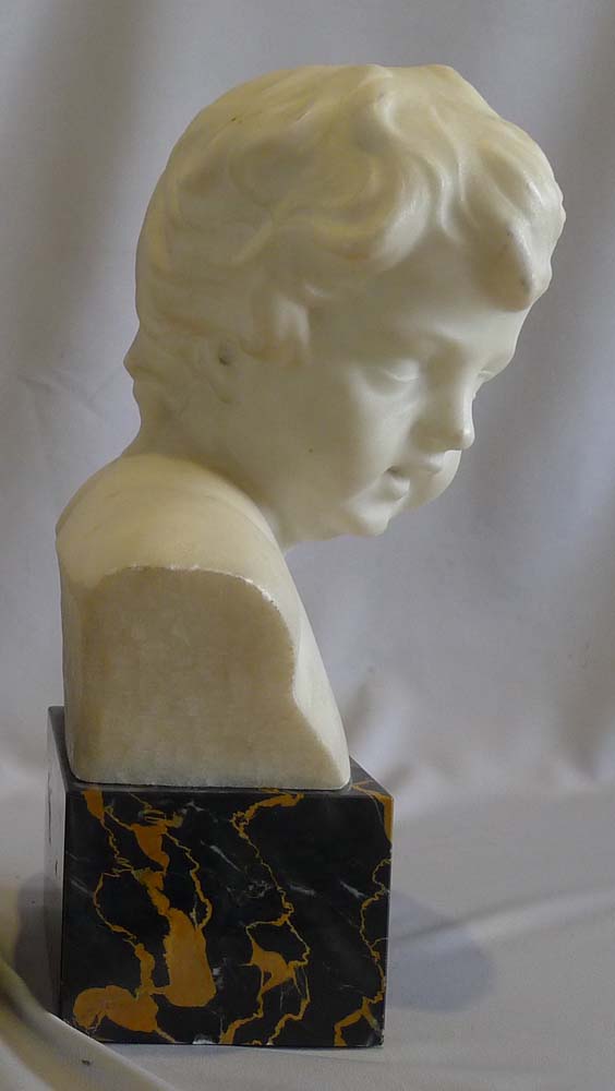 Antique pair of white marble busts of children on variegated marble bases.