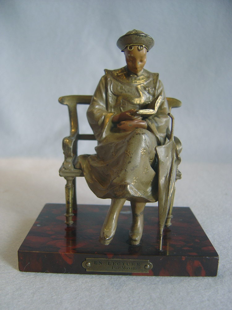 Cold painted bronze of oriental student on rouge marble base signed Maxim.