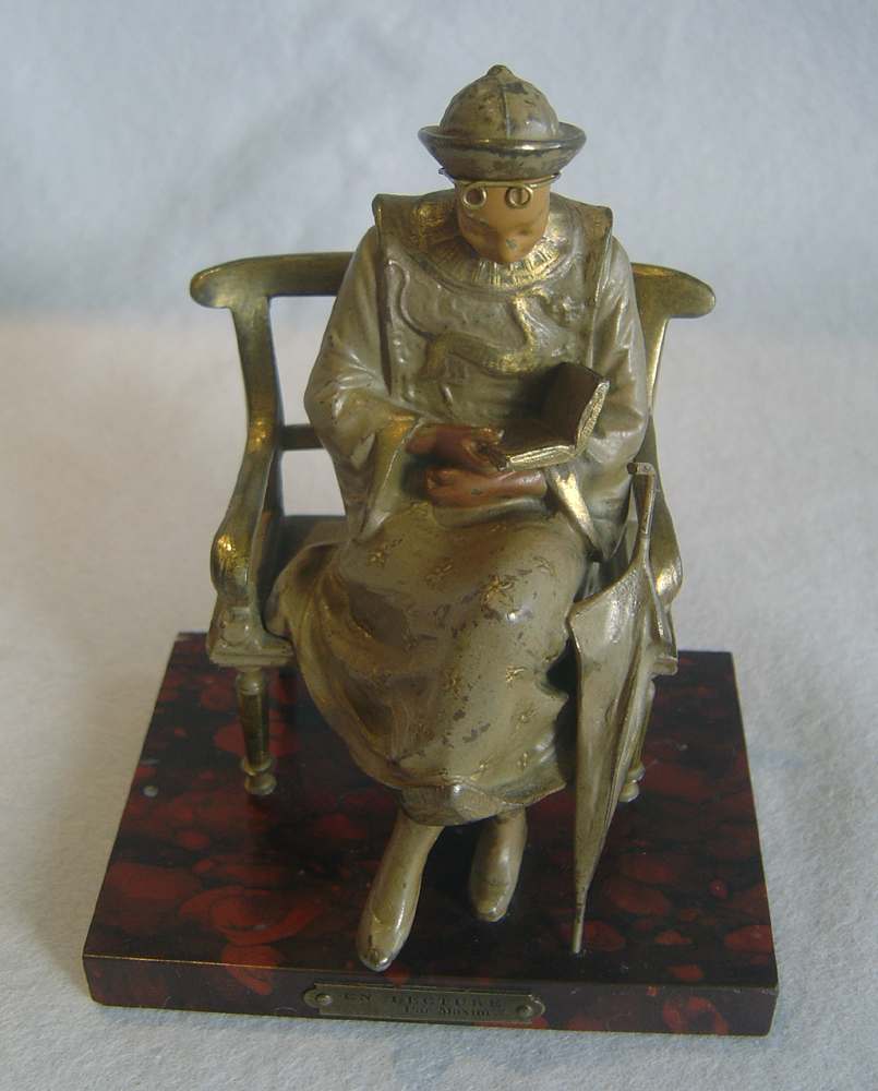 Cold painted bronze of oriental student on rouge marble base signed Maxim.