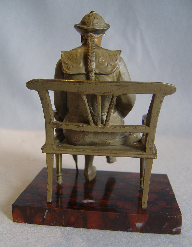 Cold painted bronze of oriental student on rouge marble base signed Maxim.
