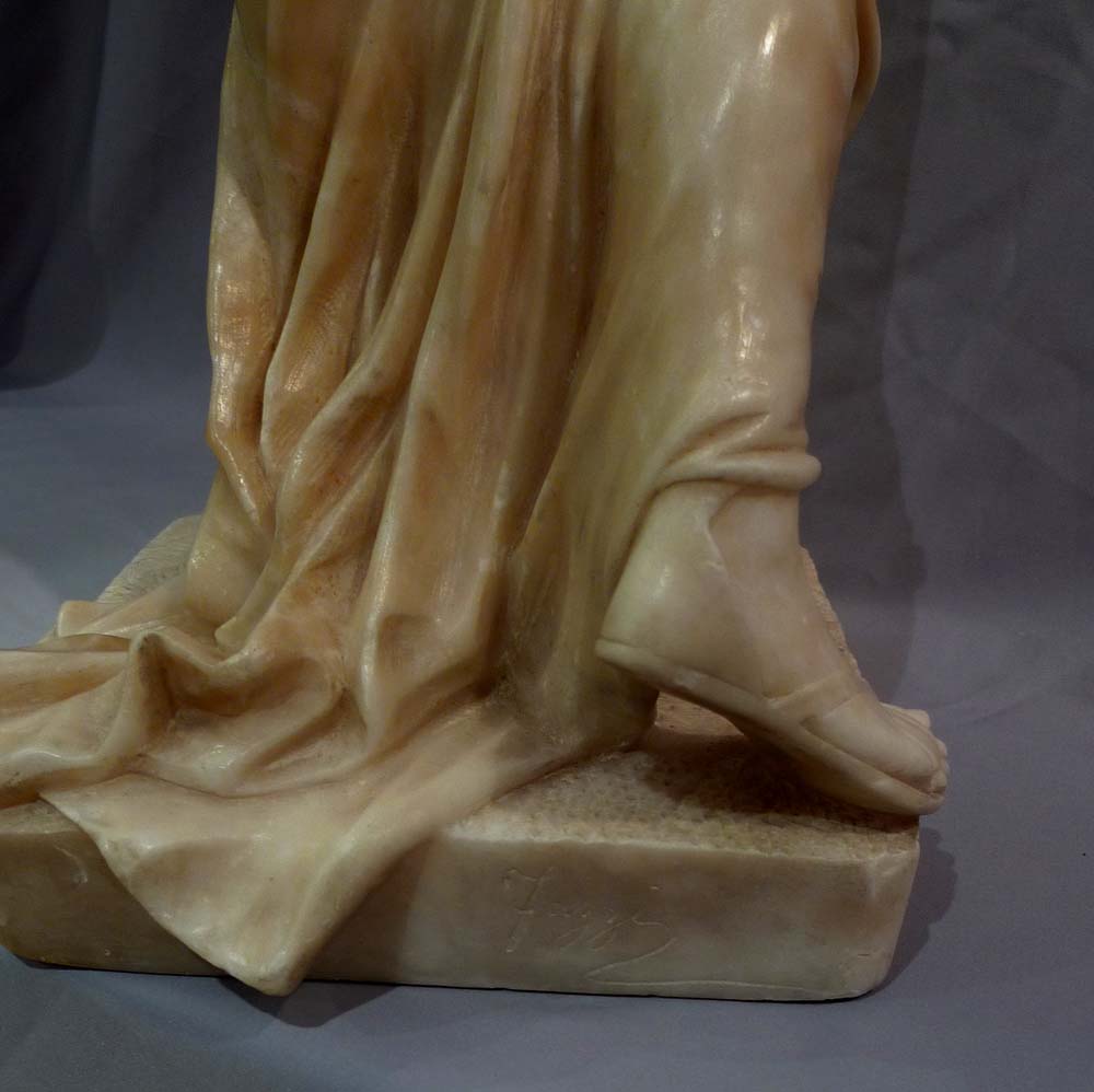 Art Nouveau alabaster figure of a maiden with her dress slipping.