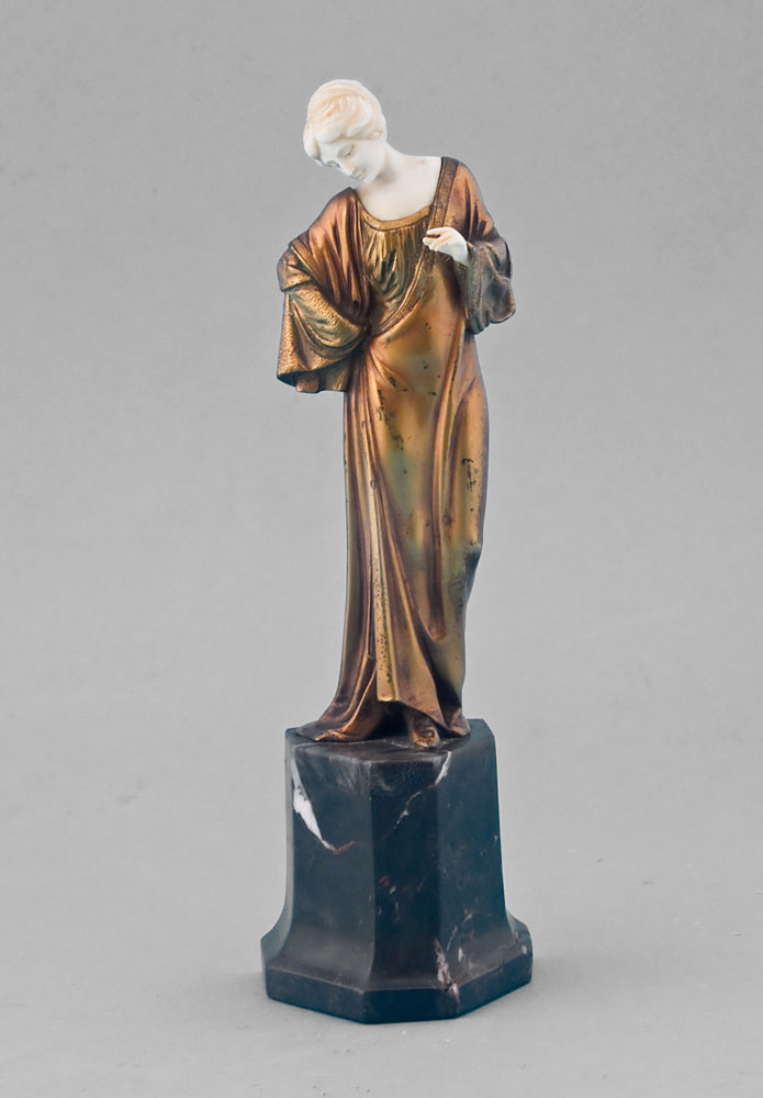 Art Deco ivory and gilt bronze statuette of lady on shaped marble base.