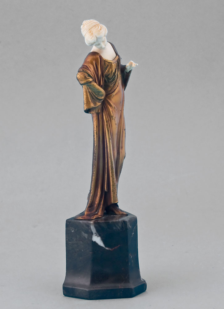 Art Deco ivory and gilt bronze statuette of lady on shaped marble base.