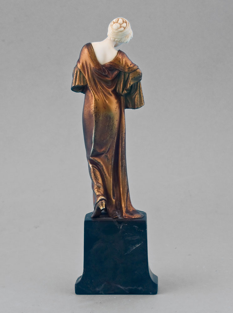 Art Deco ivory and gilt bronze statuette of lady on shaped marble base.