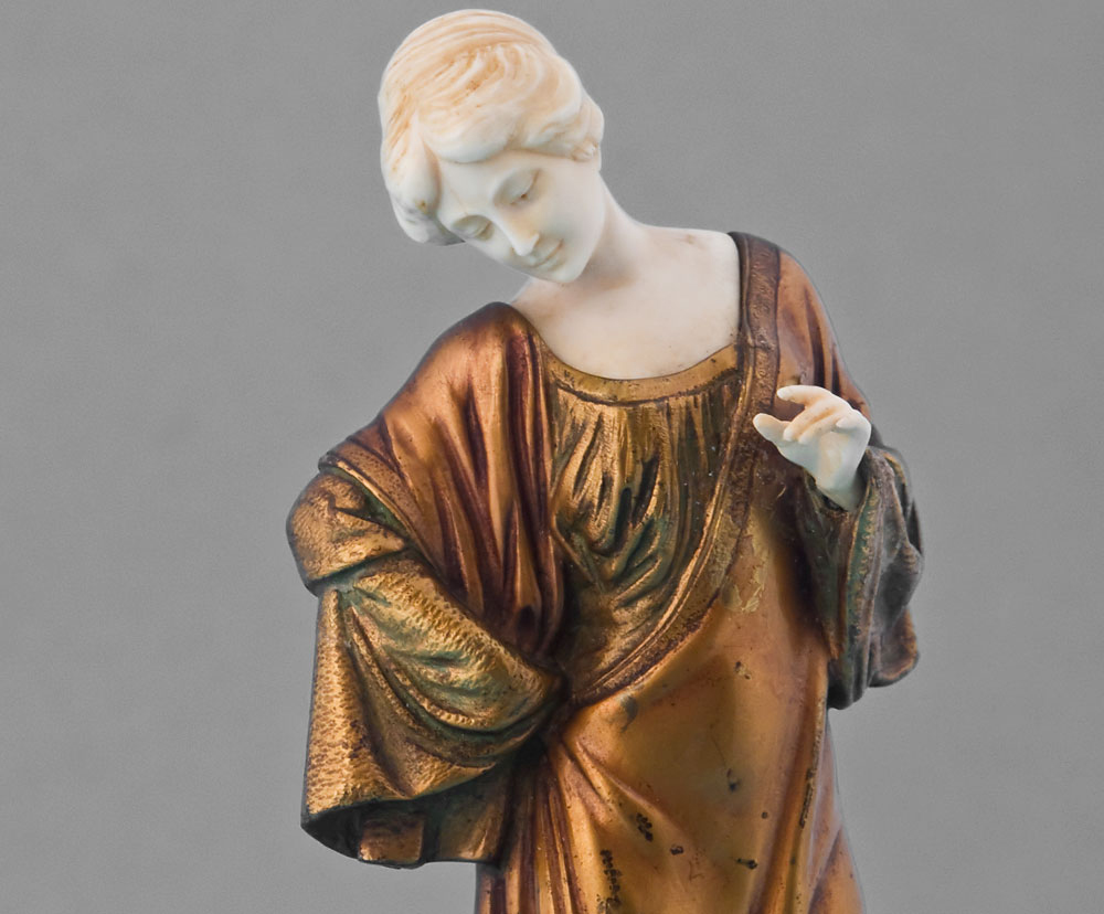 Art Deco ivory and gilt bronze statuette of lady on shaped marble base.