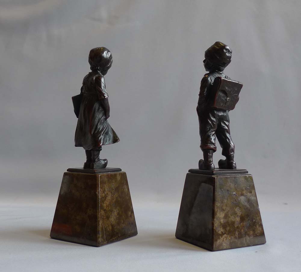 Art Deco pair of bronze girl and boy on marble bases.