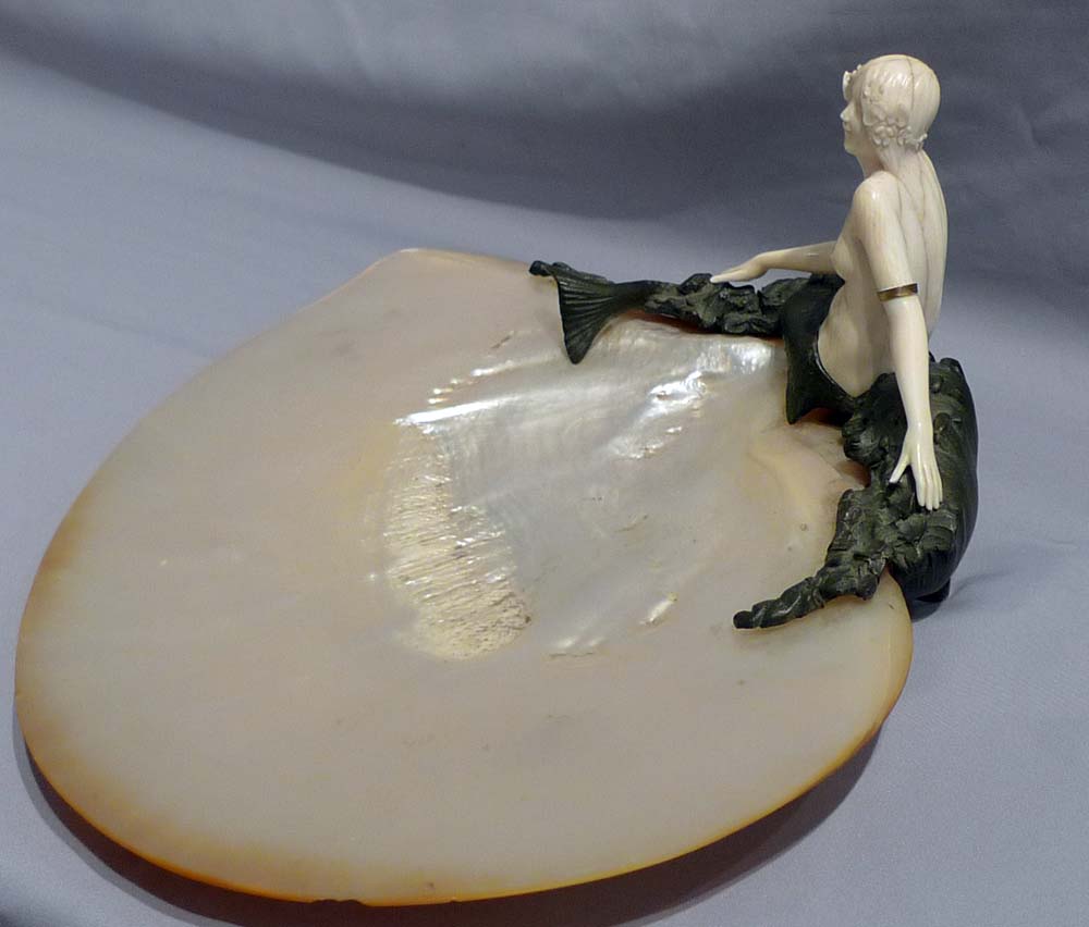 Art Deco bronze and ivory figure of a mermaid on a mother of pearl shell.