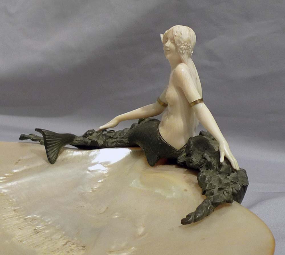 Art Deco bronze and ivory figure of a mermaid on a mother of pearl shell.