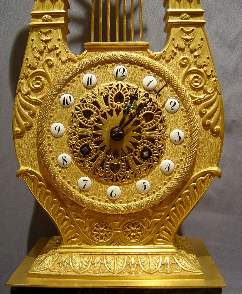 Antique French Empire marble and ormolu Apollo Lyre clock.