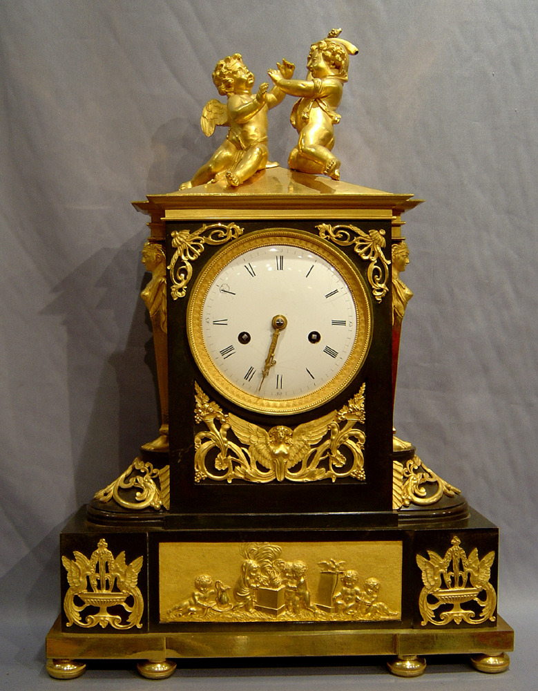 Antique French Directoire ormolu and patinated bronze clock with Egyptian theme.