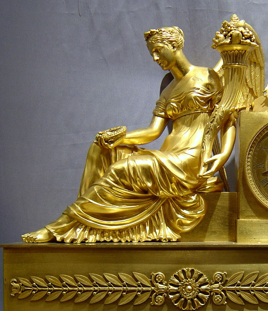 Antique French ormolu mantel clock of winged maiden.