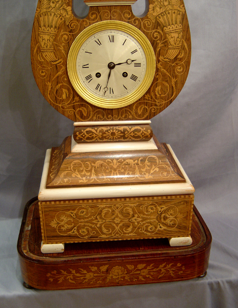 Antique French Louis Philippe Lyre clock in rosewood and marquetry under original glass dome.