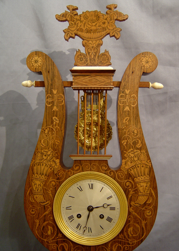Antique French Louis Philippe Lyre clock in rosewood and marquetry under original glass dome.