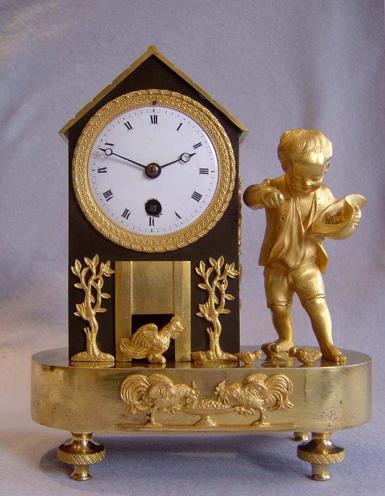 Antique French Empire genre clock of boy feeding chickens.