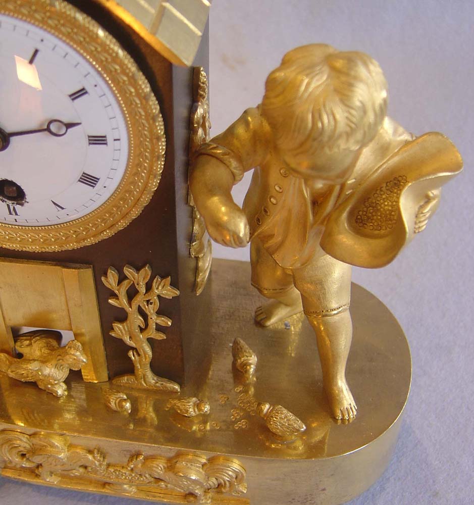 Antique French Empire genre clock of boy feeding chickens.