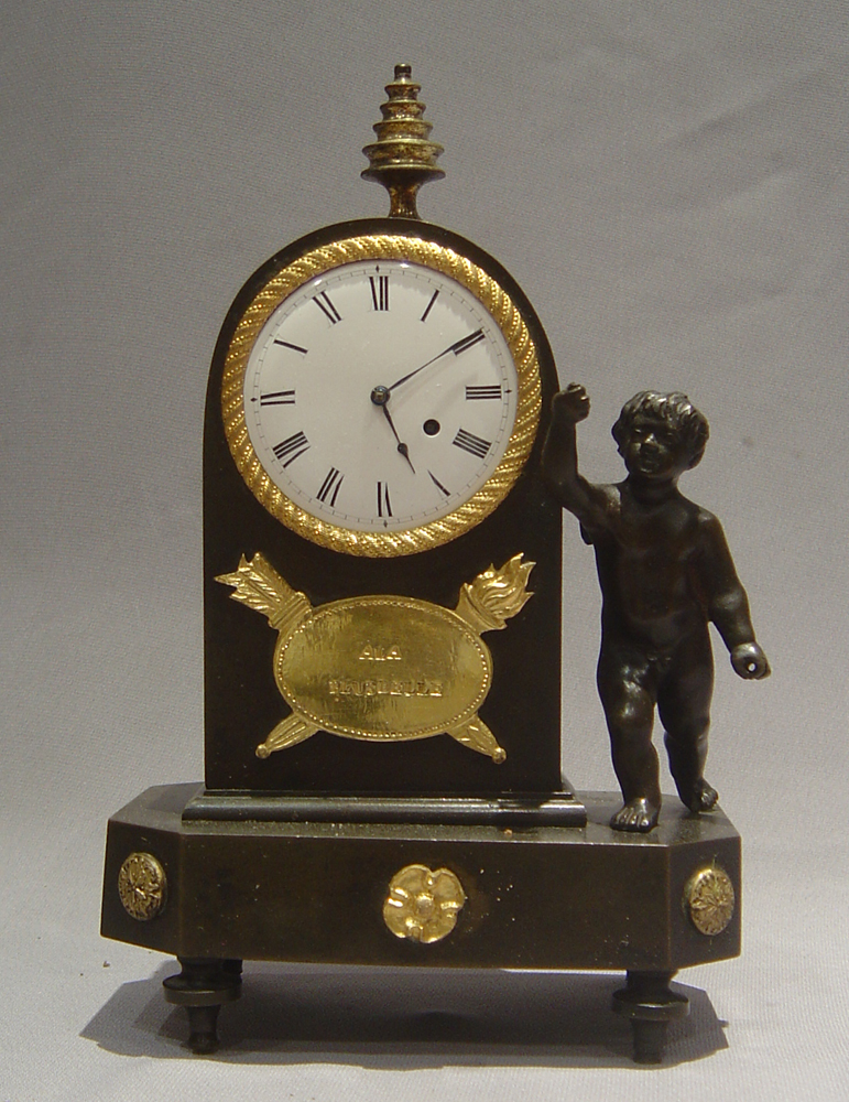 English Regency antique miniature mantel clock in patinated bronze and ormolu.
