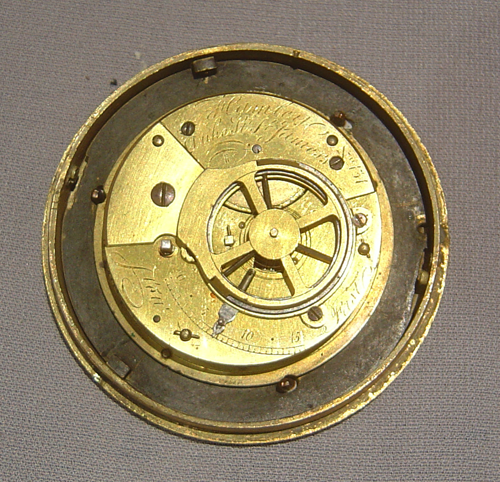 English Regency antique miniature mantel clock in patinated bronze and ormolu.
