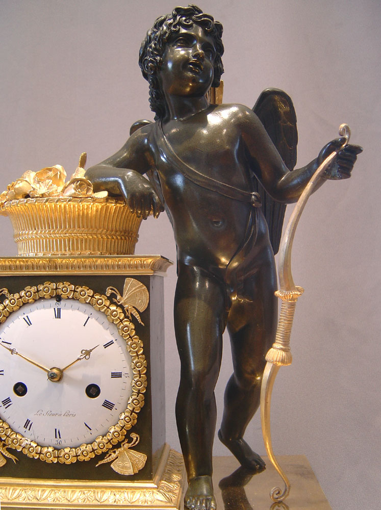 French Empire antique clock by Ledieur in marble, patinated bronze and ormolu.