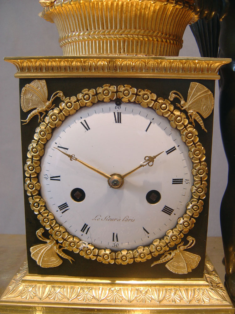 French Empire antique clock by Ledieur in marble, patinated bronze and ormolu.