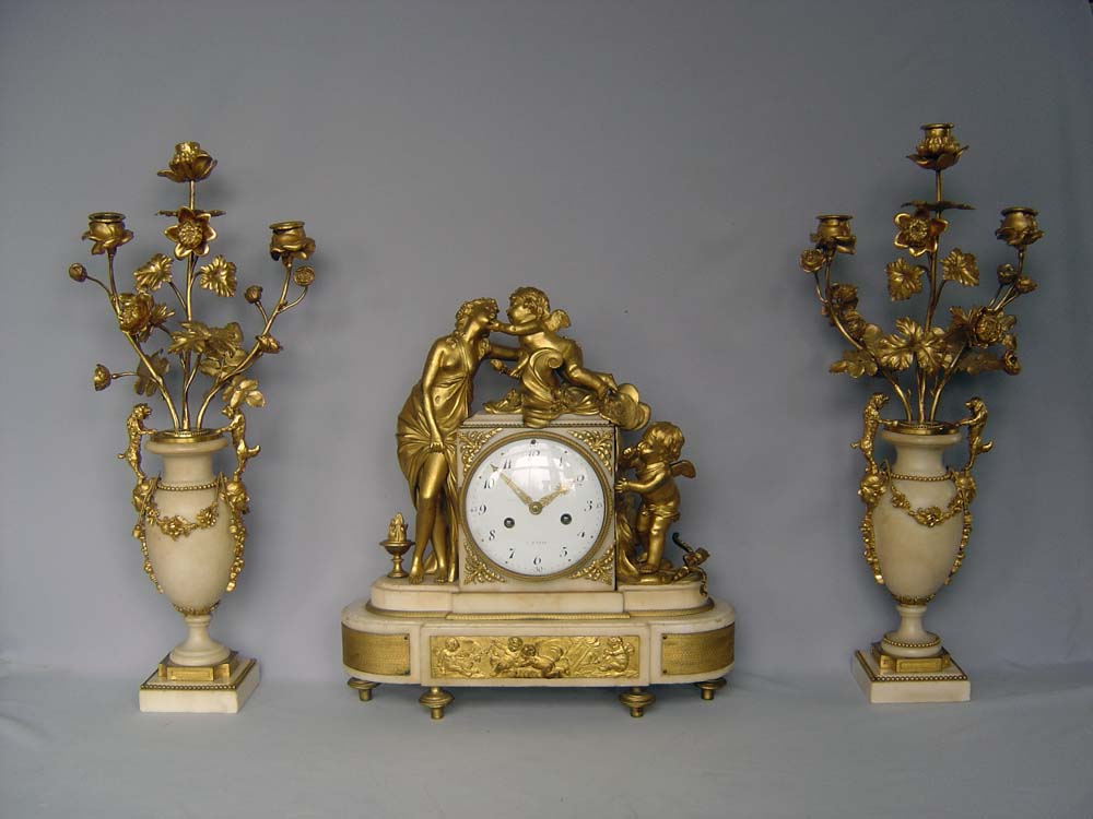 Antique Louis XVI French white marble and ormolu clock set signed Heron a Paris.