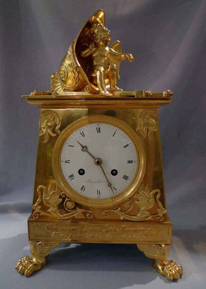 Antique Empire clock in ormolu signed Bergmiller and having military Trophies.