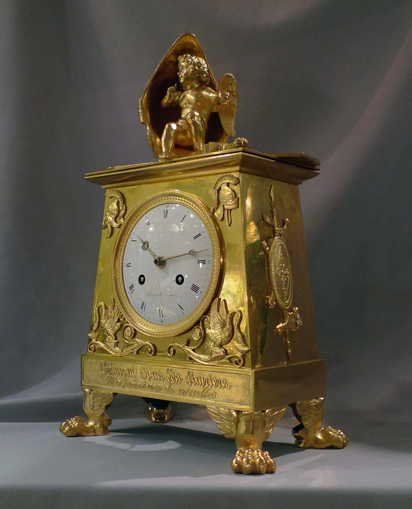 Antique Empire clock in ormolu signed Bergmiller and having military Trophies.