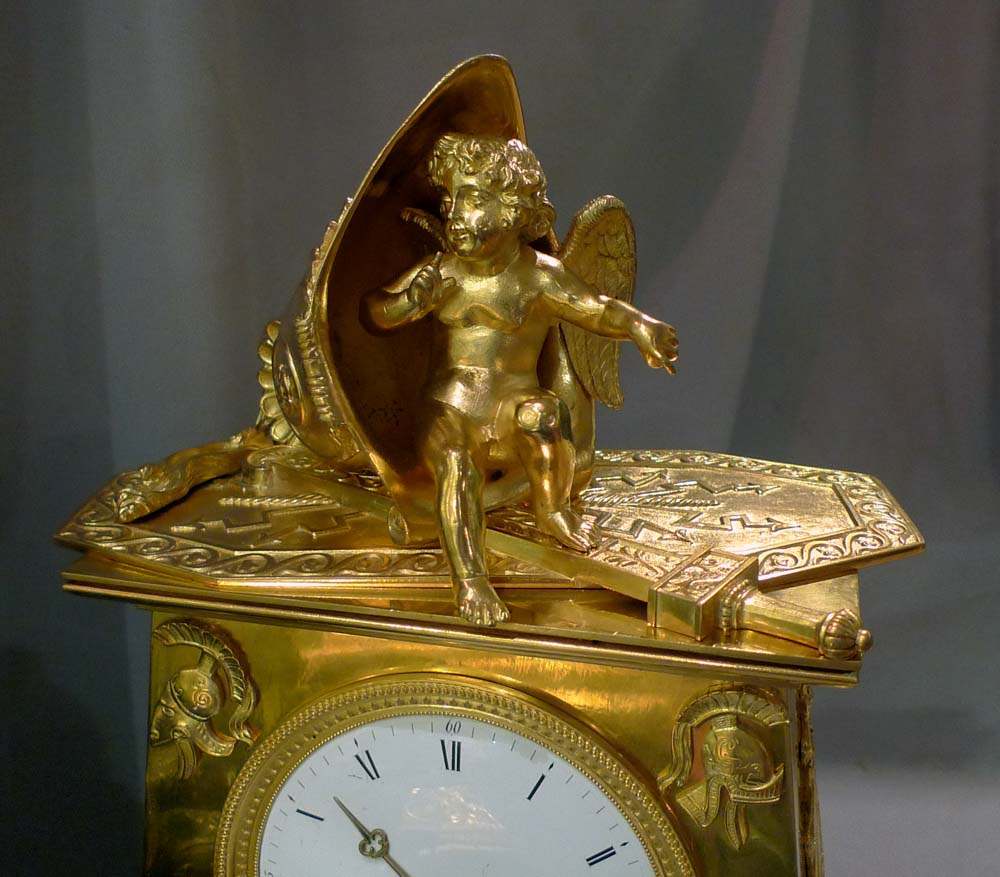 Antique Empire clock in ormolu signed Bergmiller and having military Trophies.