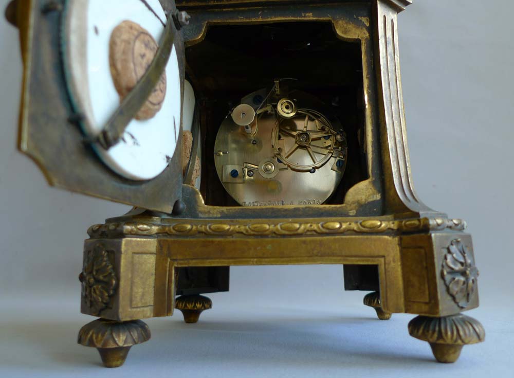 Antique urn clock of porcelain and ormolu signed Balthazar.