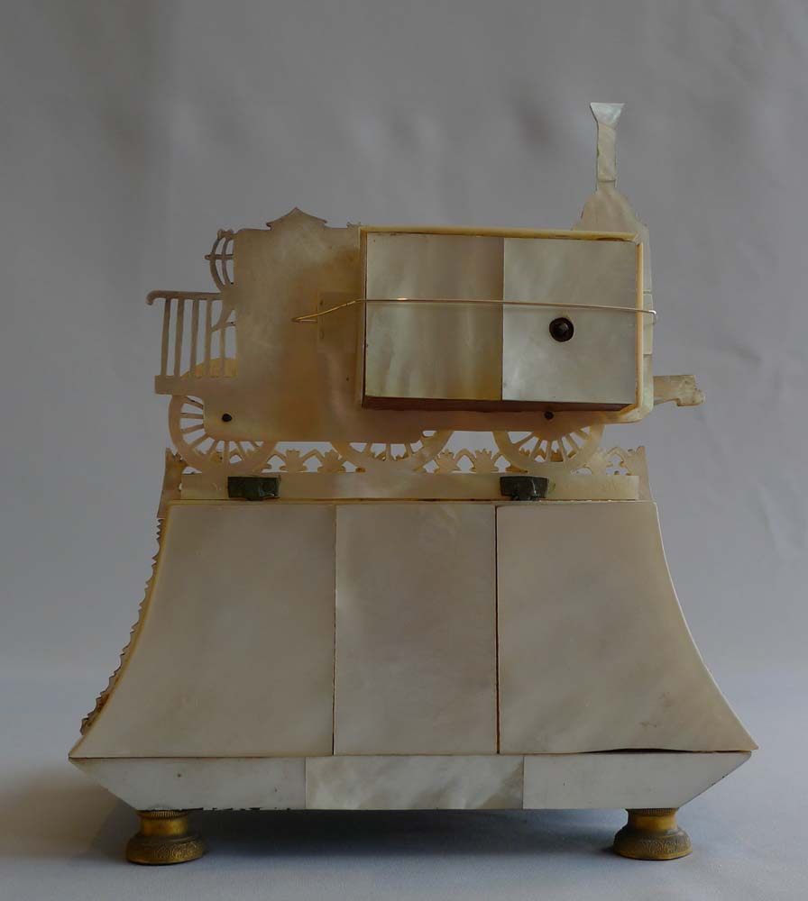 Antique Palais Royal Zapler clock in locomotive form marked Hamburg set on ormolu mounted desk set.