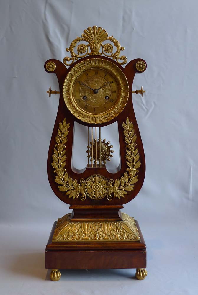 French antique Charles X period lyre clock in mahogany and ormolu.