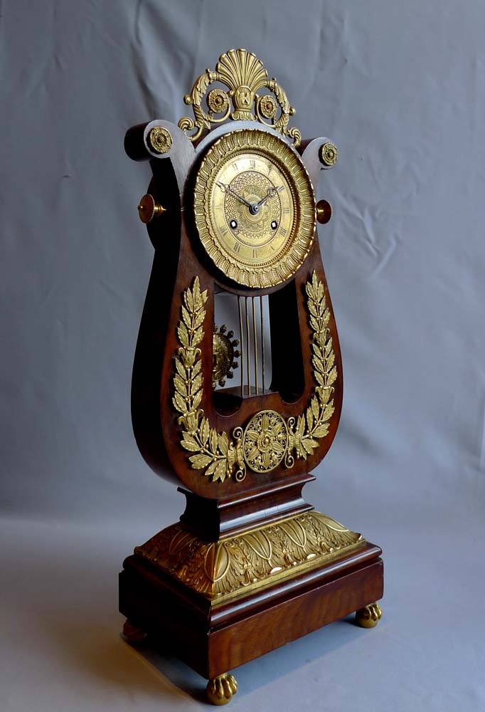 French antique Charles X period lyre clock in mahogany and ormolu.