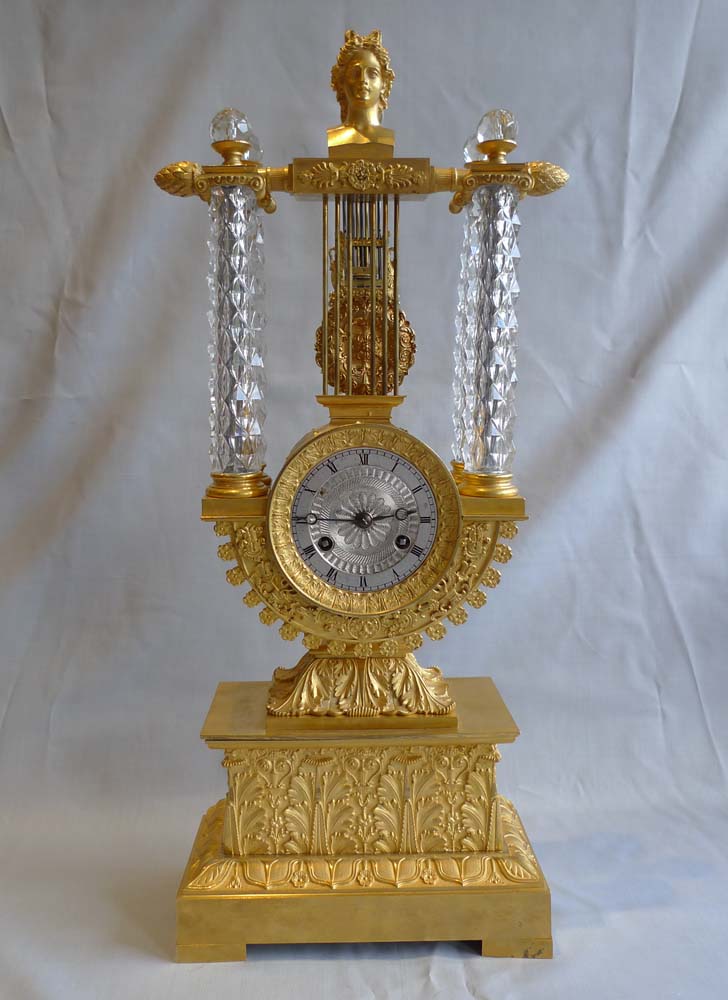 Rare antique mantel clock in crystal and ormolu, Charles X period with remote pendulum.