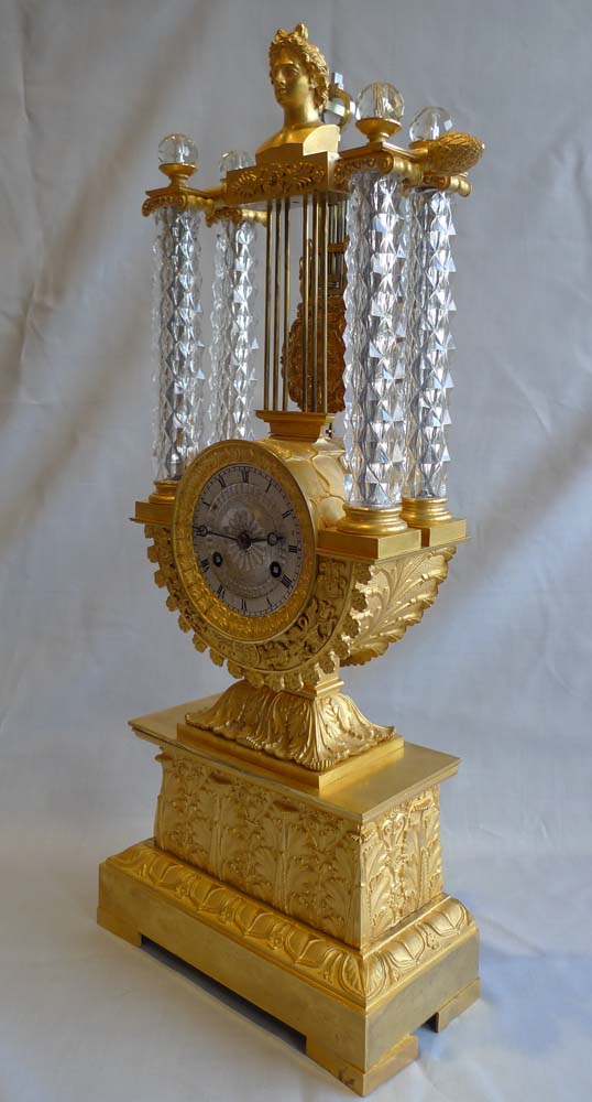Rare antique mantel clock in crystal and ormolu, Charles X period with remote pendulum.