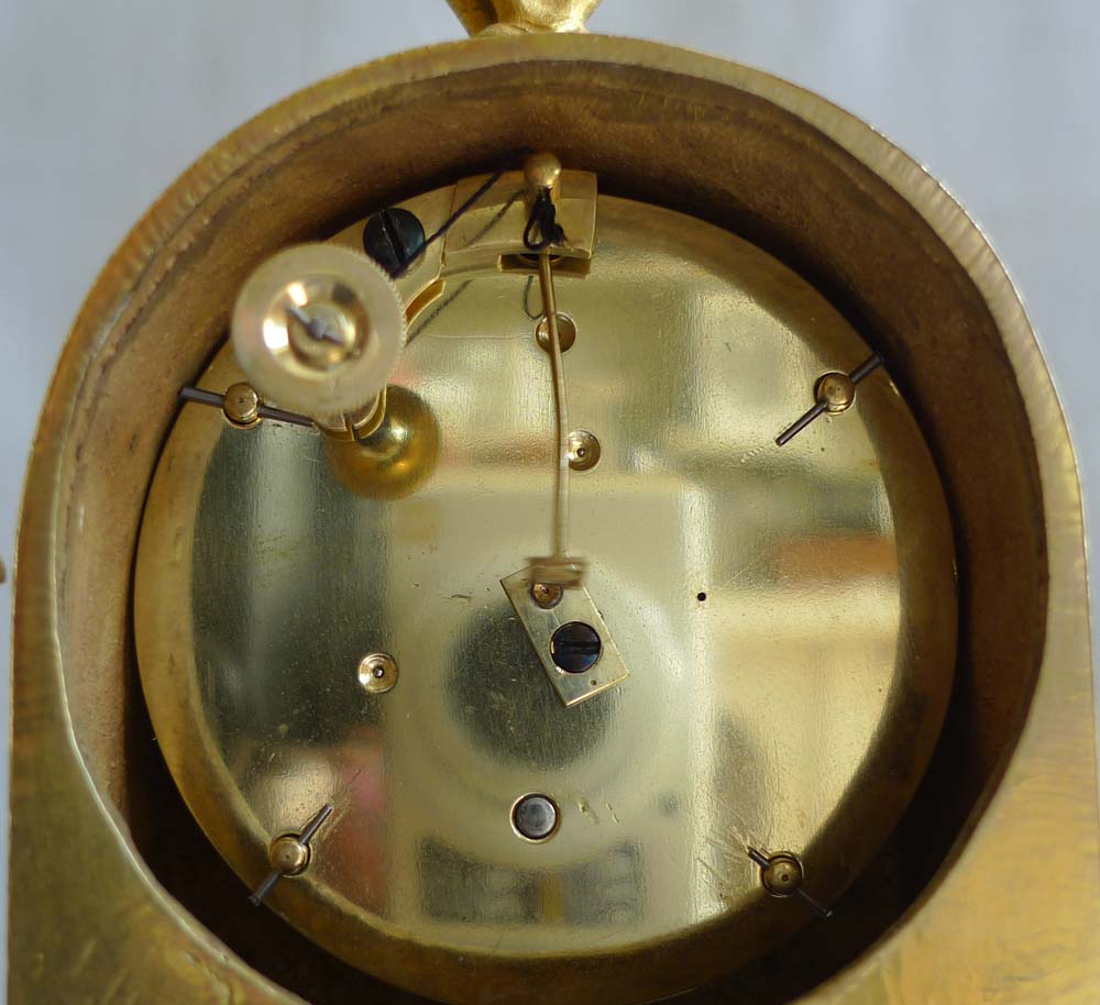 Antique mantel clock French Empire in ormolu and of small size.