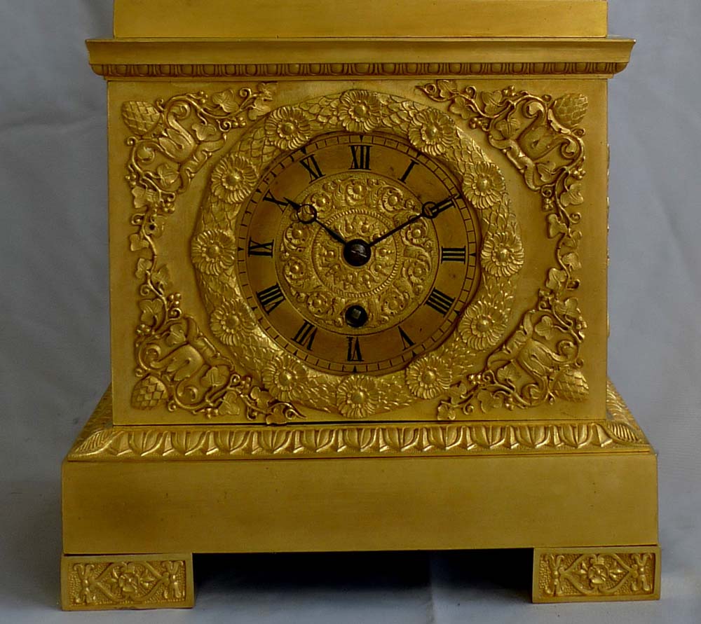 Antique French Empire mantel clock in ormolu of Cupid holding a horse.