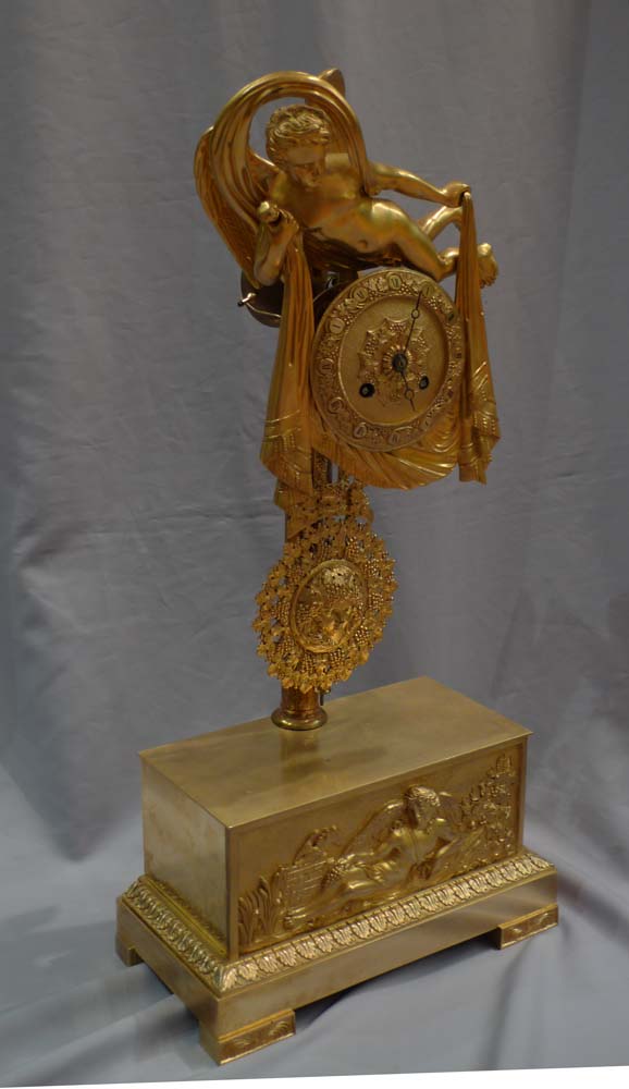 Antique French 19th century mantel clock of Cupid floating over clouds.