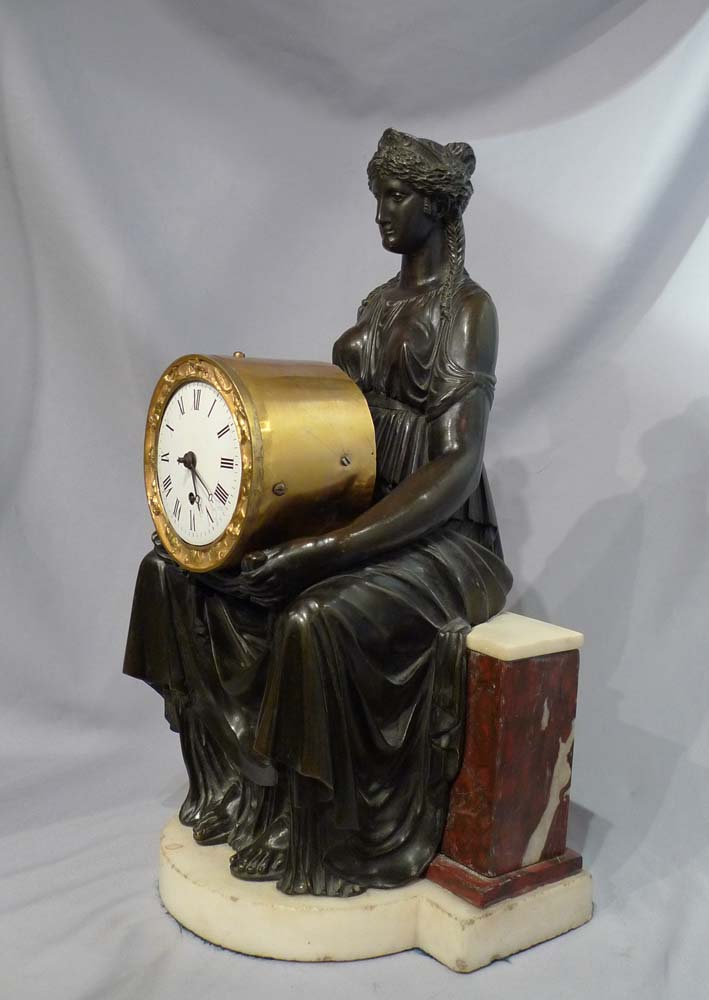 Antique English Regency mantel clock of Cybele sitting on her throne.