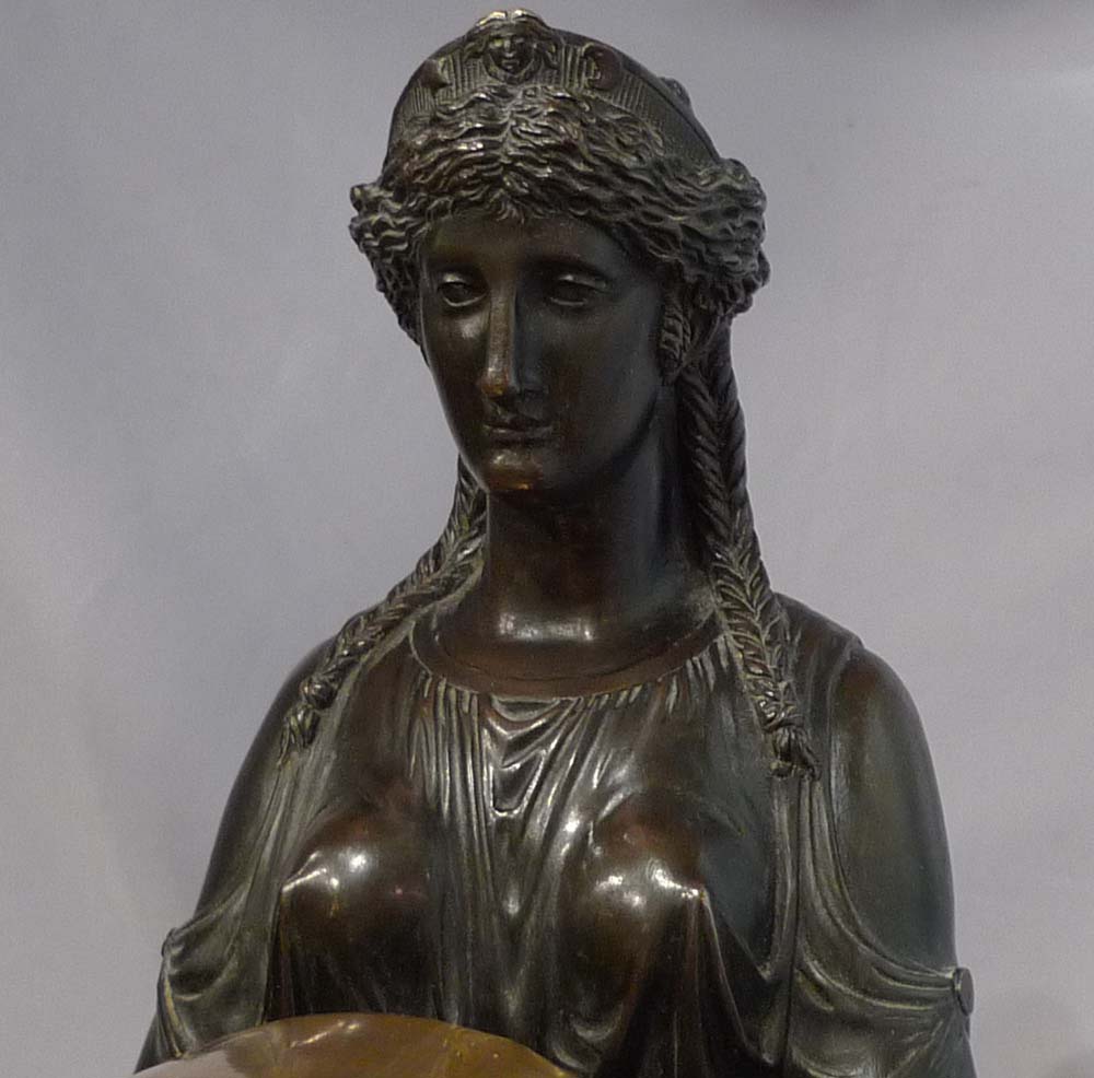 Antique English Regency mantel clock of Cybele sitting on her throne.