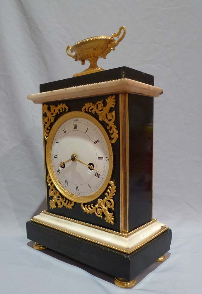 Antique French Directoire marble and ormolu mantel clock.