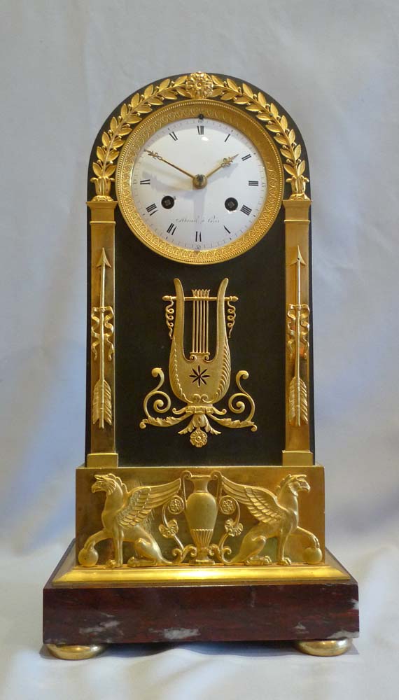 French Empire antique mantel clock in ormolu, patinated bronze and marble signed Mesnil.