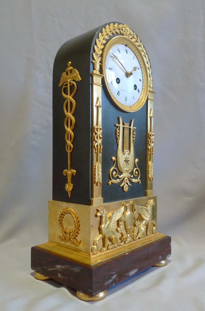 French Empire antique mantel clock in ormolu, patinated bronze and marble signed Mesnil.
