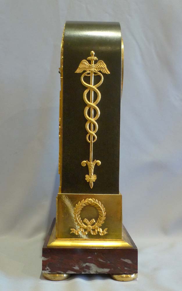 French Empire antique mantel clock in ormolu, patinated bronze and marble signed Mesnil.