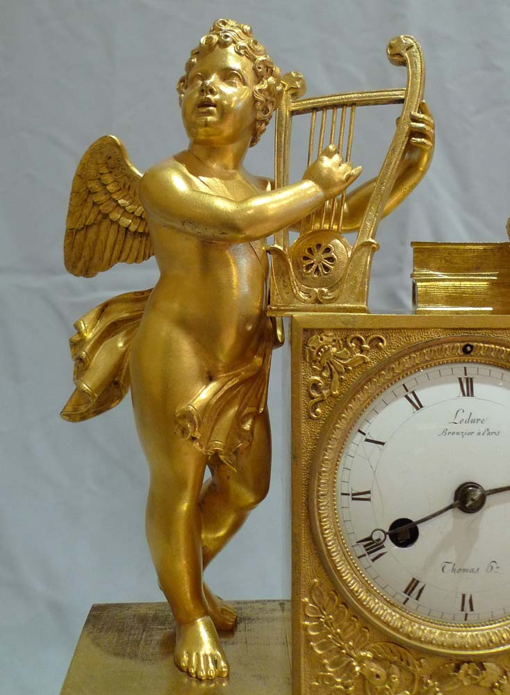 Antique French Empire clock of cupid playing harp signed Ledure bronzier & Thomas hr.