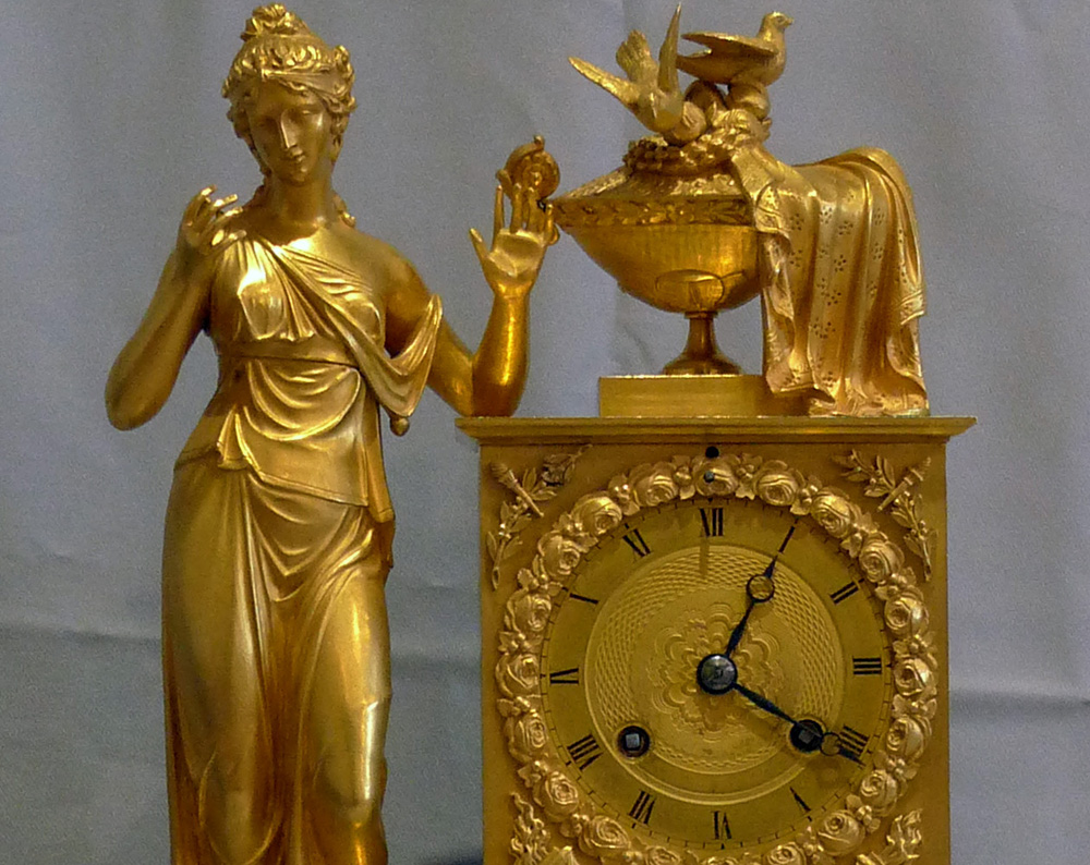 Antique French Empire clock of woman standing.