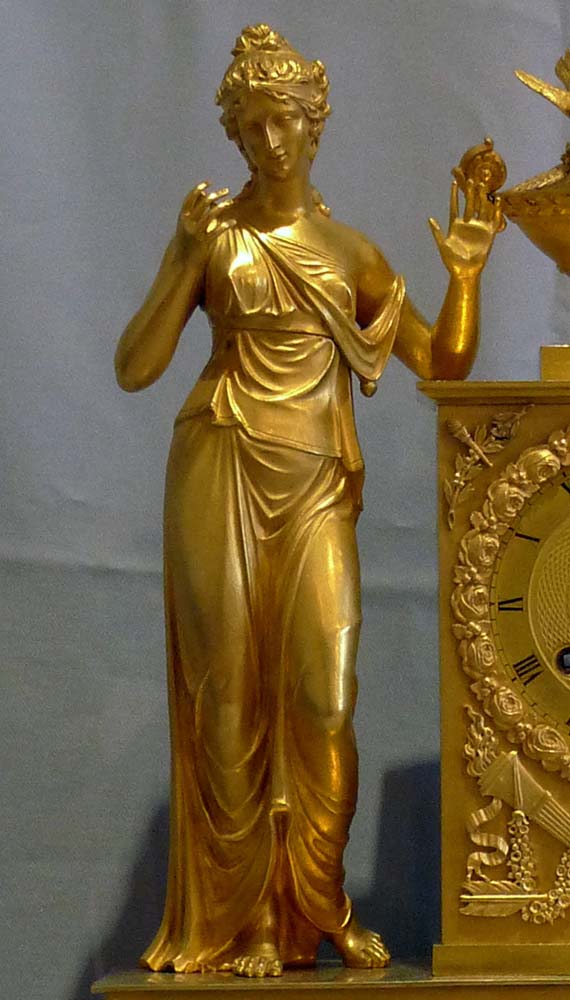 Antique French Empire clock of woman standing.