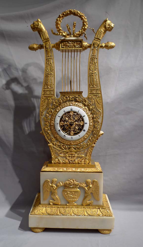Antique French Charles X ormolu and alabaster lyre clock.