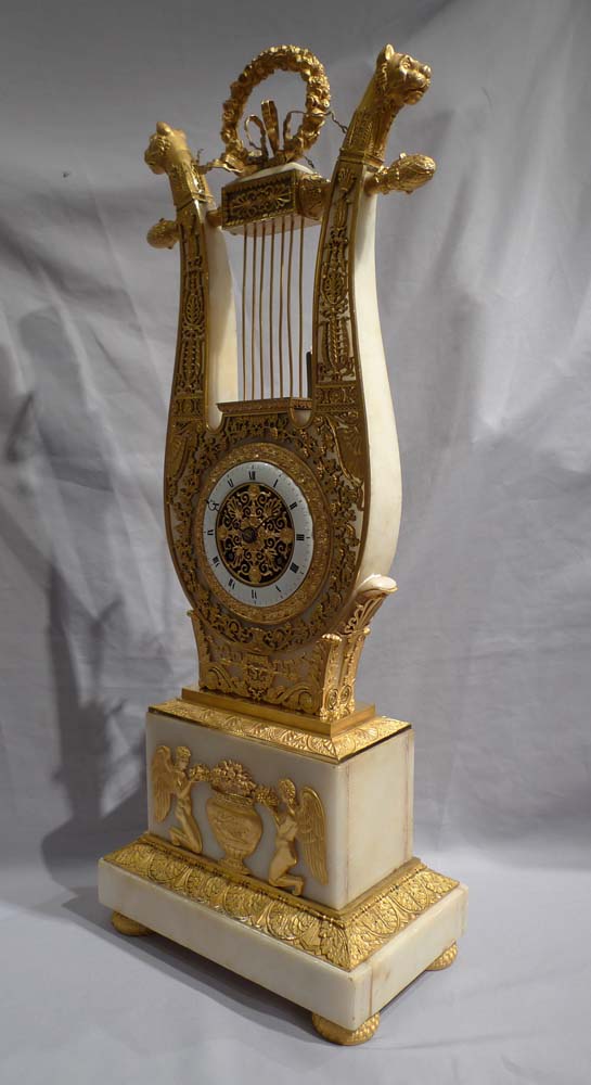 Antique French Charles X ormolu and alabaster lyre clock.