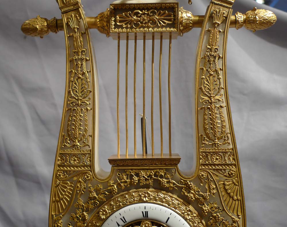 Antique French Charles X ormolu and alabaster lyre clock.