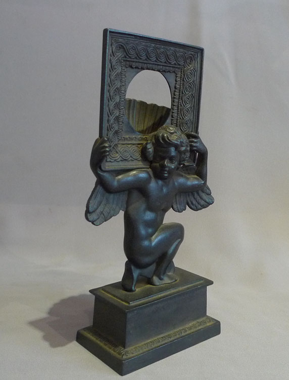 Antique Russian cast iron neo classical watchstand of cupid.